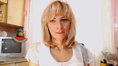 Mom is naughty in the kitchen at the camera.